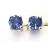 A pair of 18ct gold sapphire earrings, the single round claw set stones weighing over two carats,