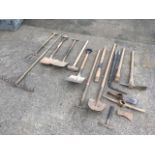 A quantity of garden tools - forks, a rake, shovels, an edge trimmer, a masonry hammer, a lump