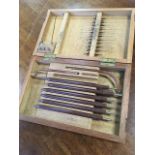 A mahogany cased medical cauterising set, with eight hand-held shaped tools fitting 27 blades of