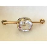 A 12ct rolled gold hinged bar pin mounted with crown setting holding a single claw set rectangular