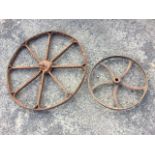 A rusty old 30in nineteenth century spoked agricultural wheel; and another with flat rim and five