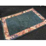 A Chinese thick pile rug woven with sea blue field framed by abstract geometric pink border. (78.5in