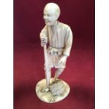 A nineteenth century carved Chinese ivory figure of a gentleman with gardening tool, mounted on