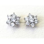 A pair of 14ct gold diamond stud earrings, each with seven brilliant cut stones set as