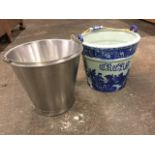 A tapering stainless steel farm milk bucket with swing handle; and a blue & white glazed ceramic