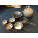 A graduated set of five copper pans riveted with iron handles; a tapering French funnel sieve with