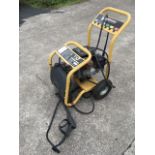 An American Wilks pressure washer, model TX650 with 8 HP petrol engine, on trolley stand.