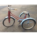 A 60s childs tricycle with sprung seat, chromed handlebars, spoked wheels, chainguard and mudguards,