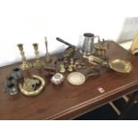 Miscellaneous metalware including a pair of brass candlesticks, a Victorian cast iron stationary