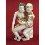 A Chinese carved netsuke depicting a young gentleman rogering his girlfriend from behind, whilst