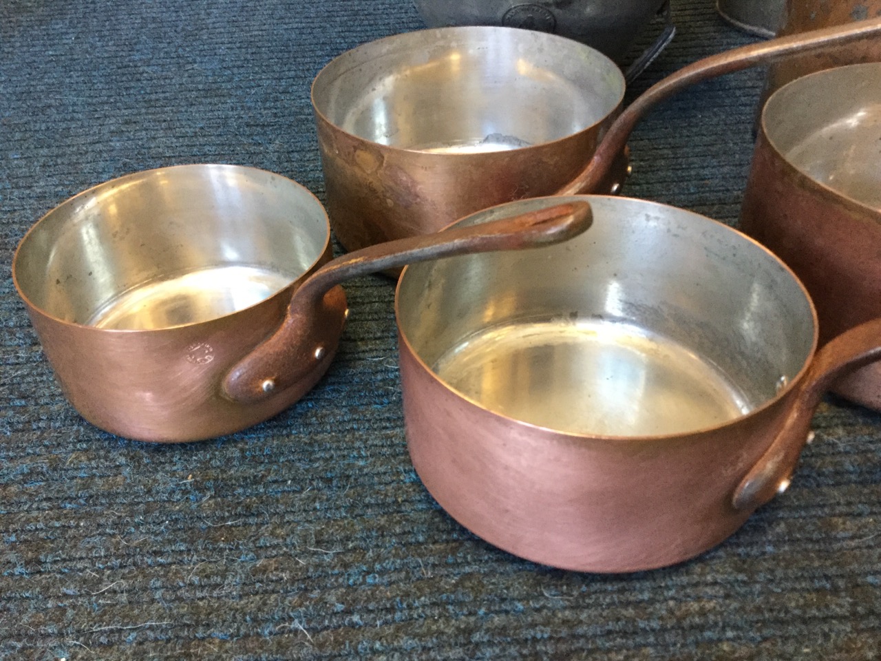 A graduated set of five copper pans riveted with iron handles; a tapering French funnel sieve with - Image 2 of 3