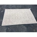 A modern Eternity rug, woven in the traditional field & border design with grey palette on ivory