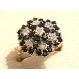 A 9ct gold sapphire & diamond cluster ring, the stones set in a dome shape on cage, mounted on a