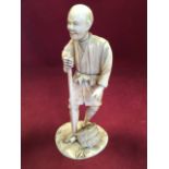 A nineteenth century carved okimono ivory figure of a gentleman with gardening tool, mounted on