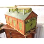 A Hornby O gauge tinplate engine shed, with doors opening both ends of pitched roof building, the