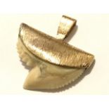 A 9ct gold sharktooth pendant, the gold mount of crescent shape with naturalist rough finish. (1.