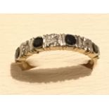 A 9ct gold sapphire & diamond two tone half eternity ring, the four bezel set sapphires in channel