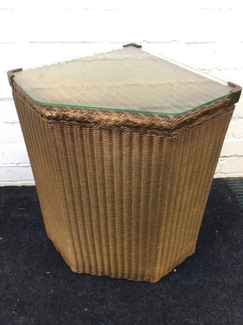 A Lloyd Loom Lusty corner linen basket, with plate glass to hinged lid.