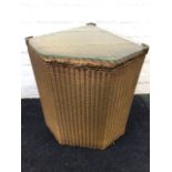 A Lloyd Loom Lusty corner linen basket, with plate glass to hinged lid.
