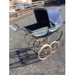 A 60s Silver Cross dolls pram, the metal body with concertina hood and vinyl cover with chrome