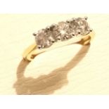 An 18ct yellow gold three stone diamond ring, the three brilliant cut claw set stones weighing