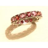 A 9ct gold tourmaline eternity ring, the band claw set with alternating oval & circular stones,