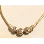 A 14ct gold diamond pendant necklace, the trio of diamonds in crescent shaped bezel mounts, the