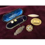 An oval Victorian gold mourning brooch having raised rectangular panel set with single star diamond;