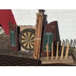 A cased dartboard with scoreboards to door interiors, including some darts; a welly-holder with