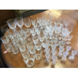 A quantity of drinking glasses including sets of wine and sherry glasses, tumblers, cut crystal,