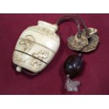 An Edwardian Chinese carved ivory four-section inro with original cords and hardwood ojemi bead, the