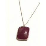 An 18ct white gold mounted bezel ruby pendant, the faceted rectangular untreated ruby of over twenty