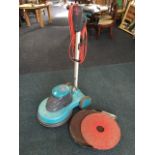 A Truvox Orbis UHS 1500 electric floor polisher with spare pads.