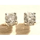 A pair of 18ct white gold diamond stud earrings, the claw set brilliant cut diamonds weighing just