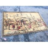A chenille wallhanging depicting an eastern streetscene framed by lozenge border, canvas lined and