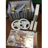 A Nintendo Wii games console with handheld controllers & covers, steering wheels, various Wii
