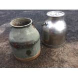 A stainless steel milk churn and cover with swing handle; and another older with brass mounts. (2)