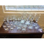 A set of eight signed wine glasses by Michael James Hunter, with funnel shaped bowls on coloured