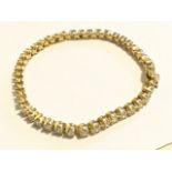 A fine 18ct yellow gold diamond bracelet, the forty four individually hinged claw set round diamonds