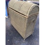 A large domed top Iinen basket with hinged lid, the interior with three divisions, having carrying