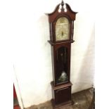 A reproduction mahogany longcase clock, with swan-neck pediment above an arched door enclosing a