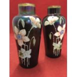 A pair of tapering irridescent lustre glass vases with tubular necks, enamelled in relief with