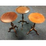 Three circular mahogany tray-top occasional tables, one with lozenge & bead moulded rim, raised on