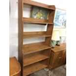 A pine open bookcase with six graduated shelves having shaped sides. (36.5in x 12.5in x 79in)