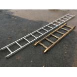 An 11ft Ramsay aluminium ladder with 13 tubular ribbed rungs; and a short pine ladder. (2)