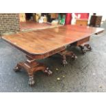 A George IV mahogany dining table, with two rounded ends and central section with drop leaves, the