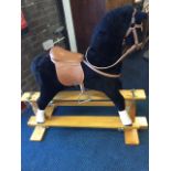 A Thoroughbred Horses upholstered rocking horse, with glass eyes and fitted with bridle, saddle