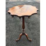 A nineteenth century circular rosewood scalloped top occasional table, the top with drop finials