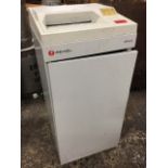 An electric Rexel 1500 auto paper shredder, with scrap paper bin in cupboard below machine, raised