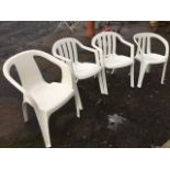 A set of four stacking white moulded armchairs with slatbacks on angled legs. (4)